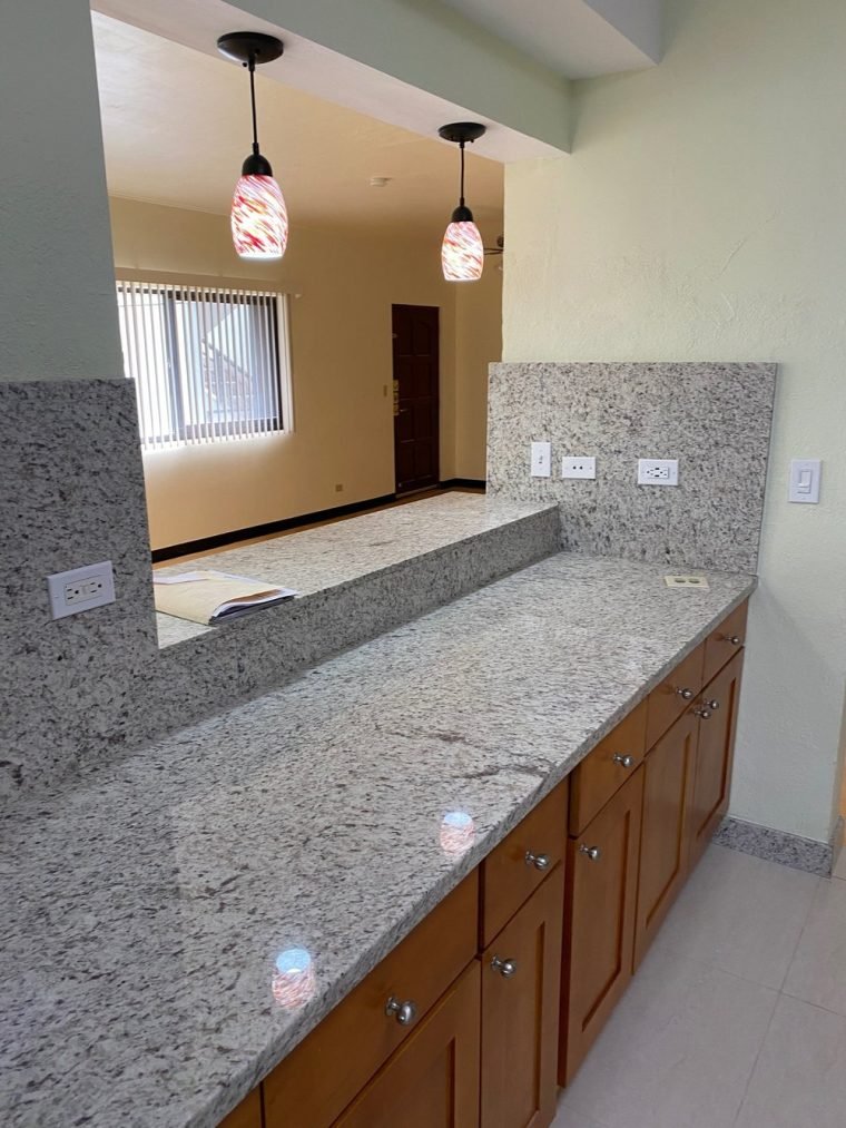 Sink relocated to centre on the front window; wall removed for a three-seat bar.