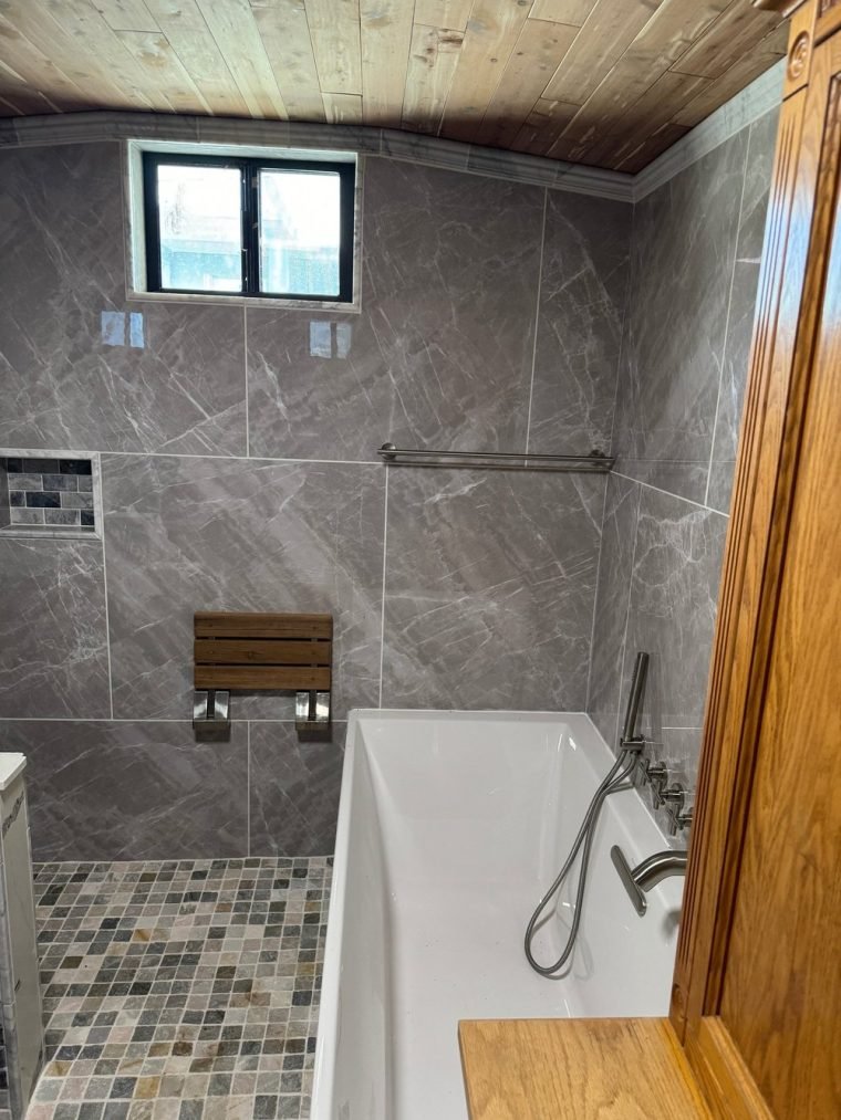 Corner vanity with double stone sinks and marble crown molding.