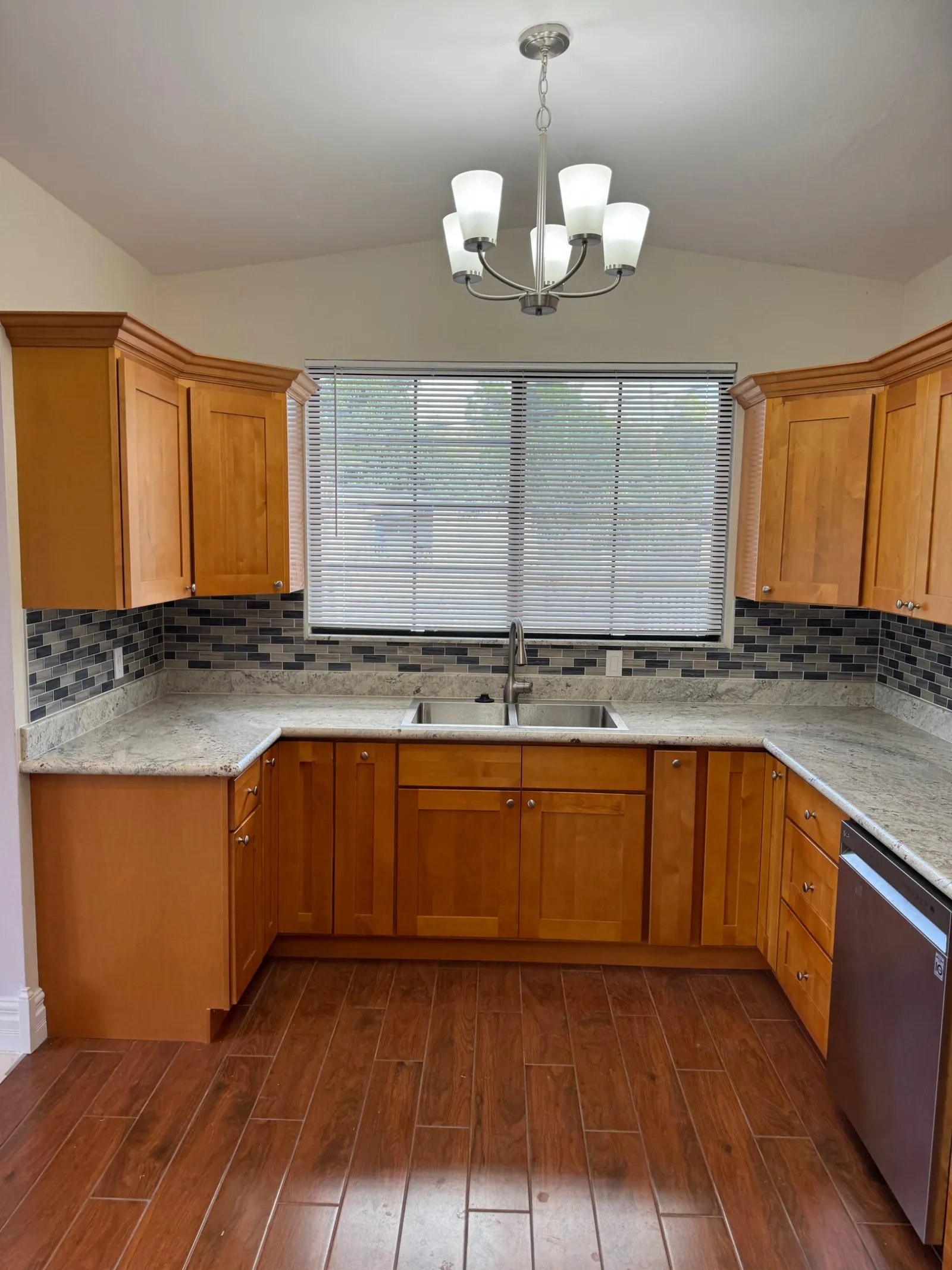 Maple shaker cabinets, granite counters and a glass mosaic backsplash.